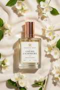Crème Cashmere perfume bottle flat lay with jasmine flowers
